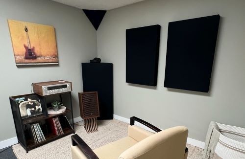 Listening room with wall-mounted acoustic panels and vintage audio equipment
